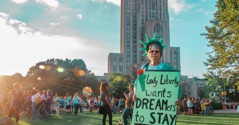 women holding pro-immigration sign