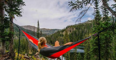 woman in hammock overlooking valley and river below