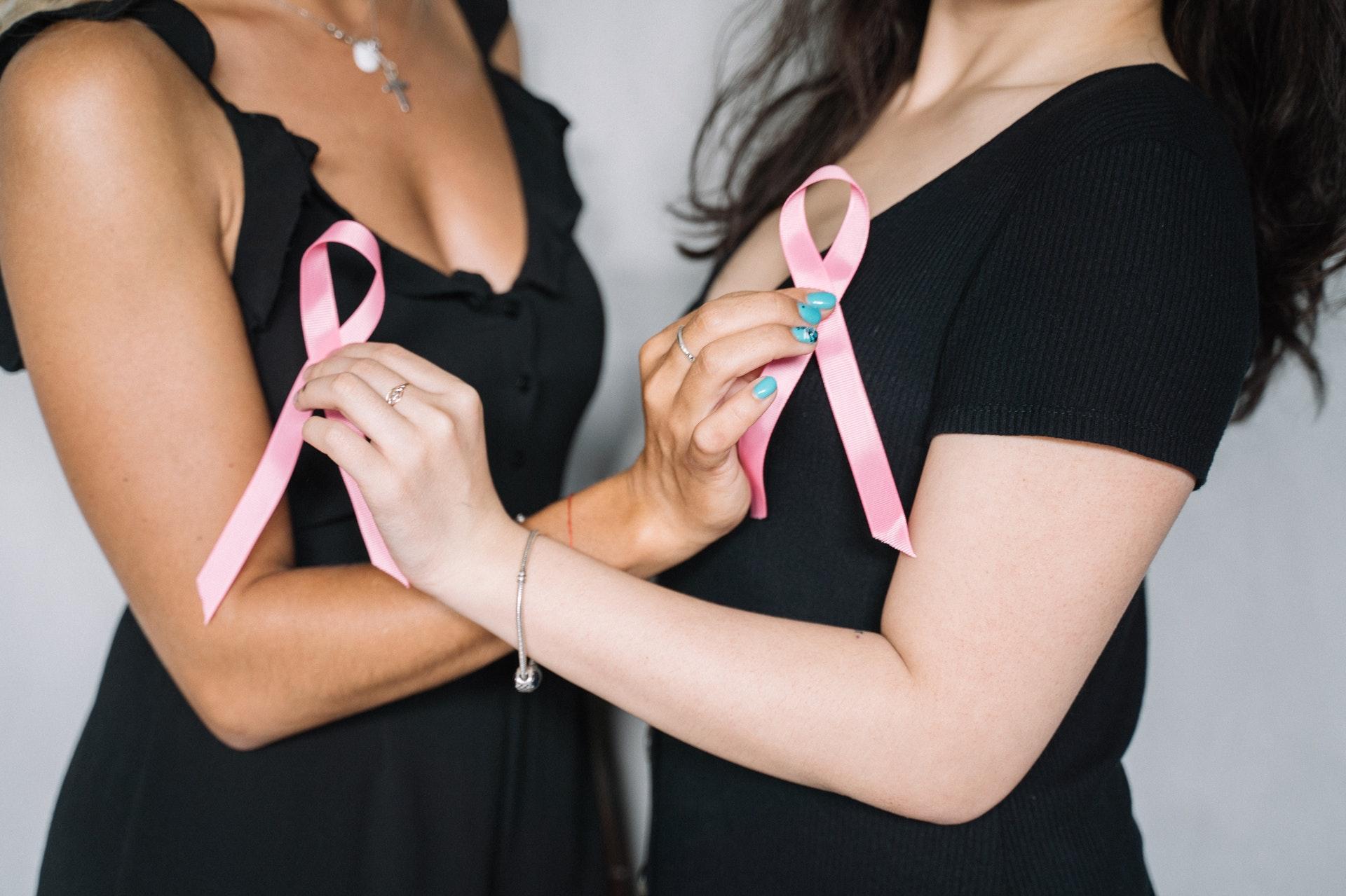 2 women with pink ribbons