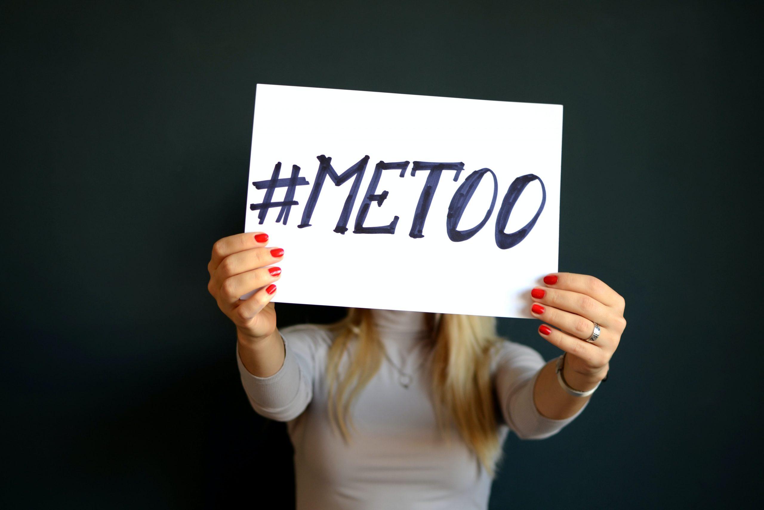 woman holding #metoo sign in front of face