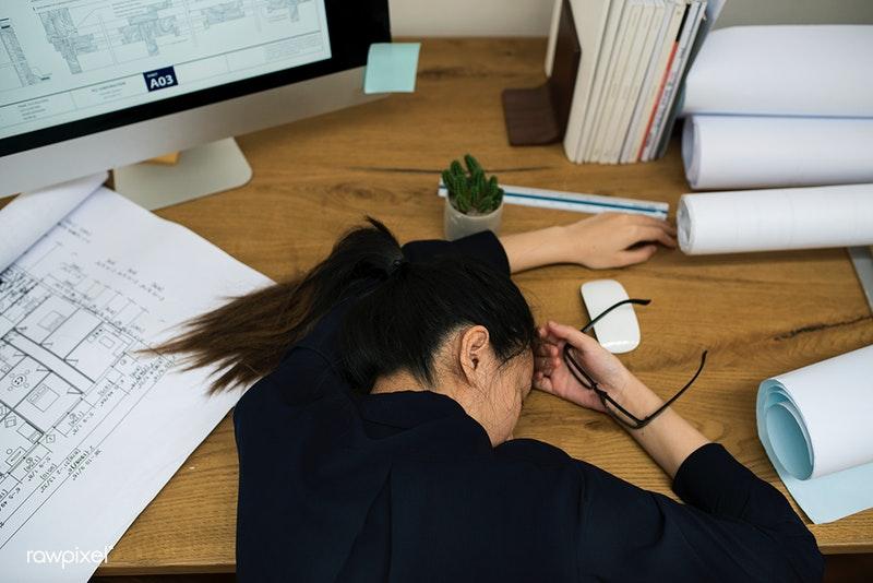 Stressed out woman napping on desk