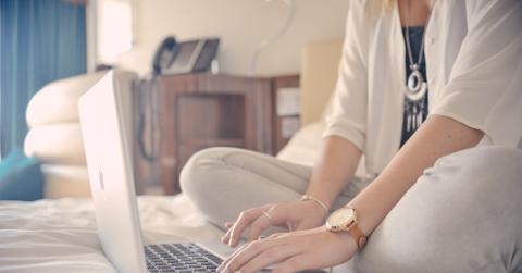 Casual-Business-Woman-Typing-On-Laptop-Whilst-In-Bed