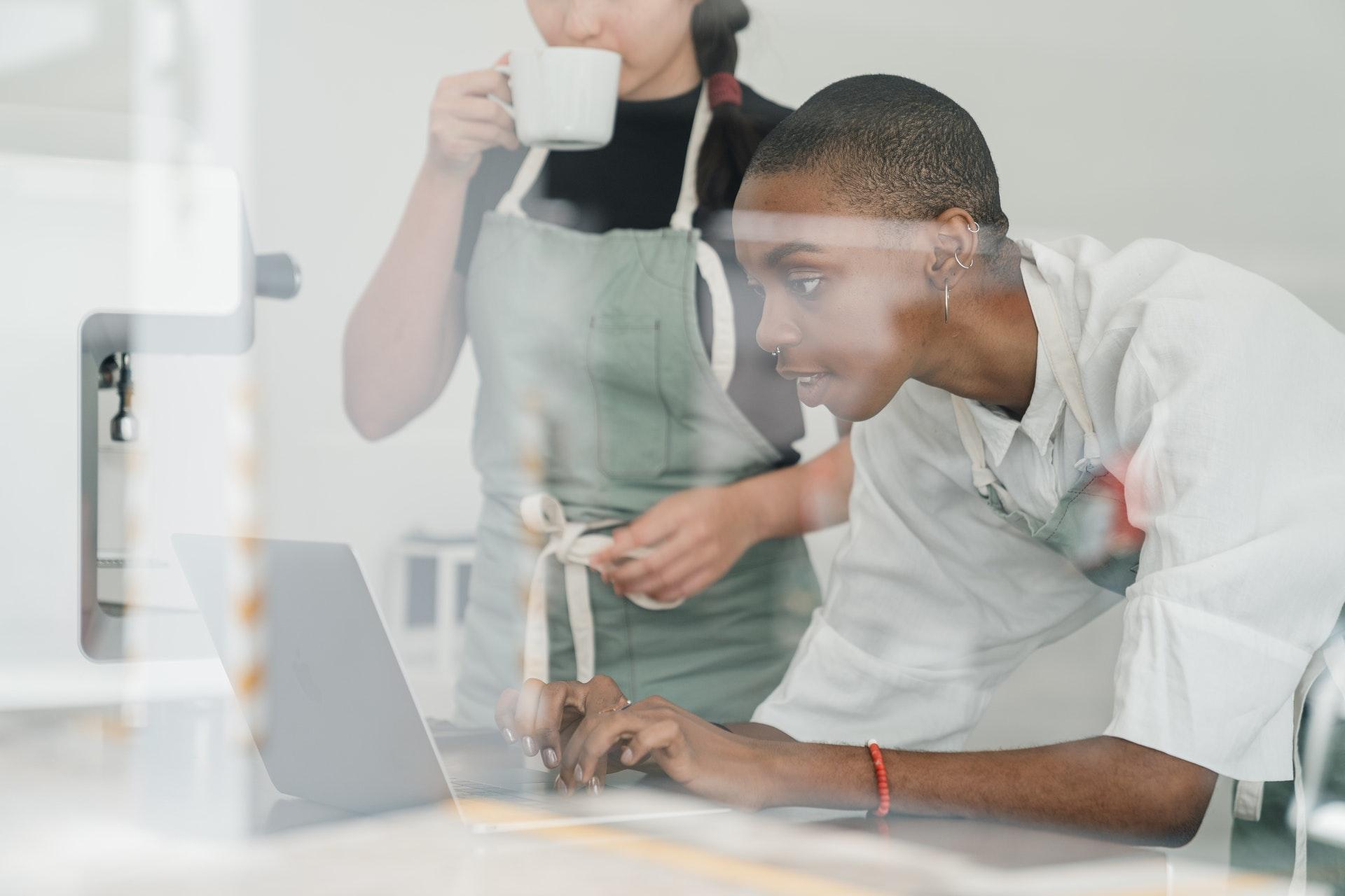 Two women looking at a laptop 