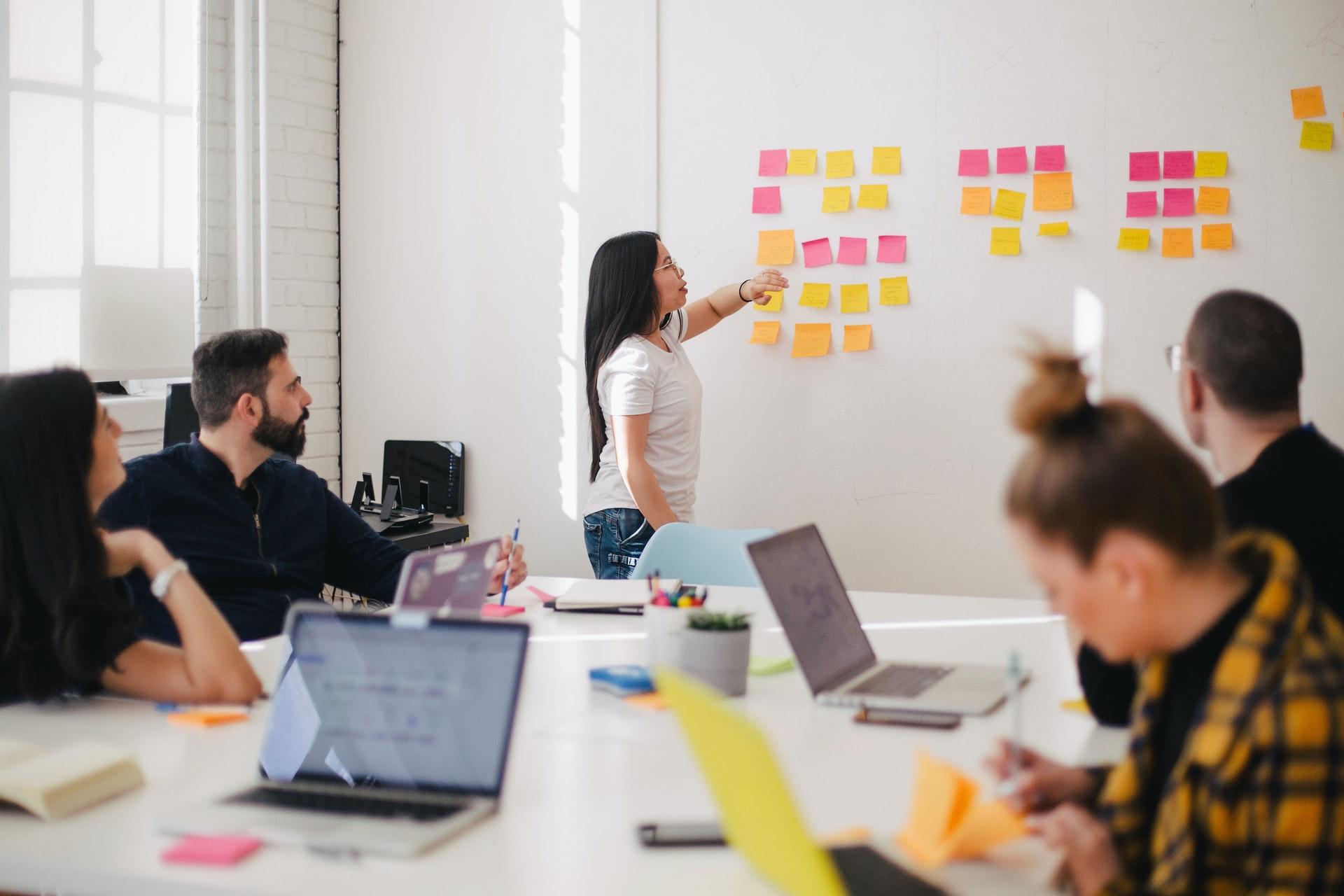 Woman in board room with sticky notes