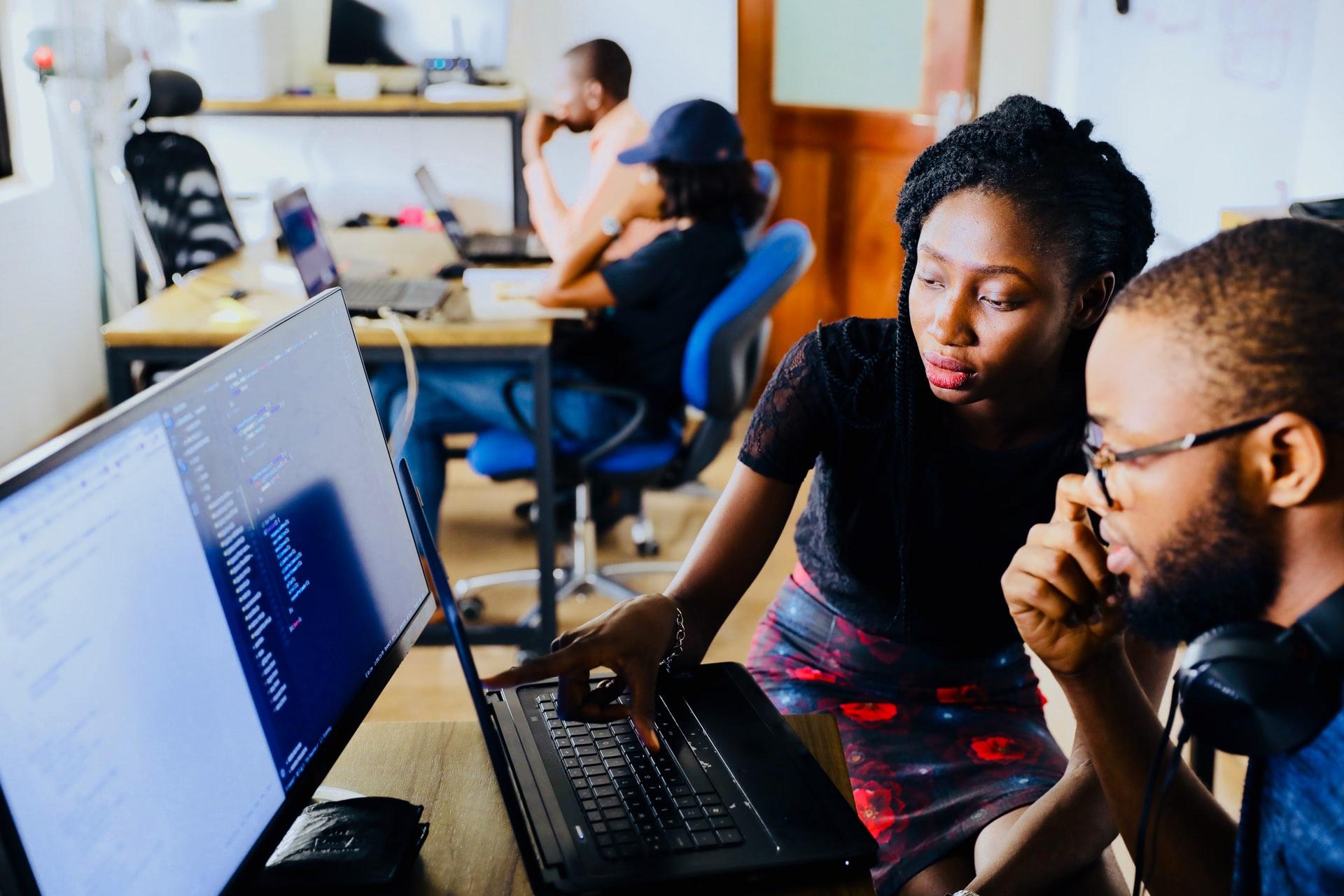 Woman and man looking at laptop