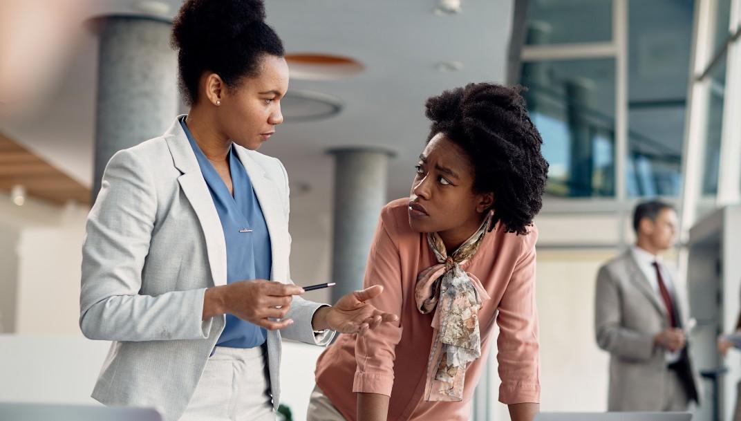 women in office talking