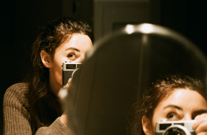 woman in mirror with camera