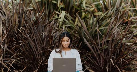 Woman sitting with laptop