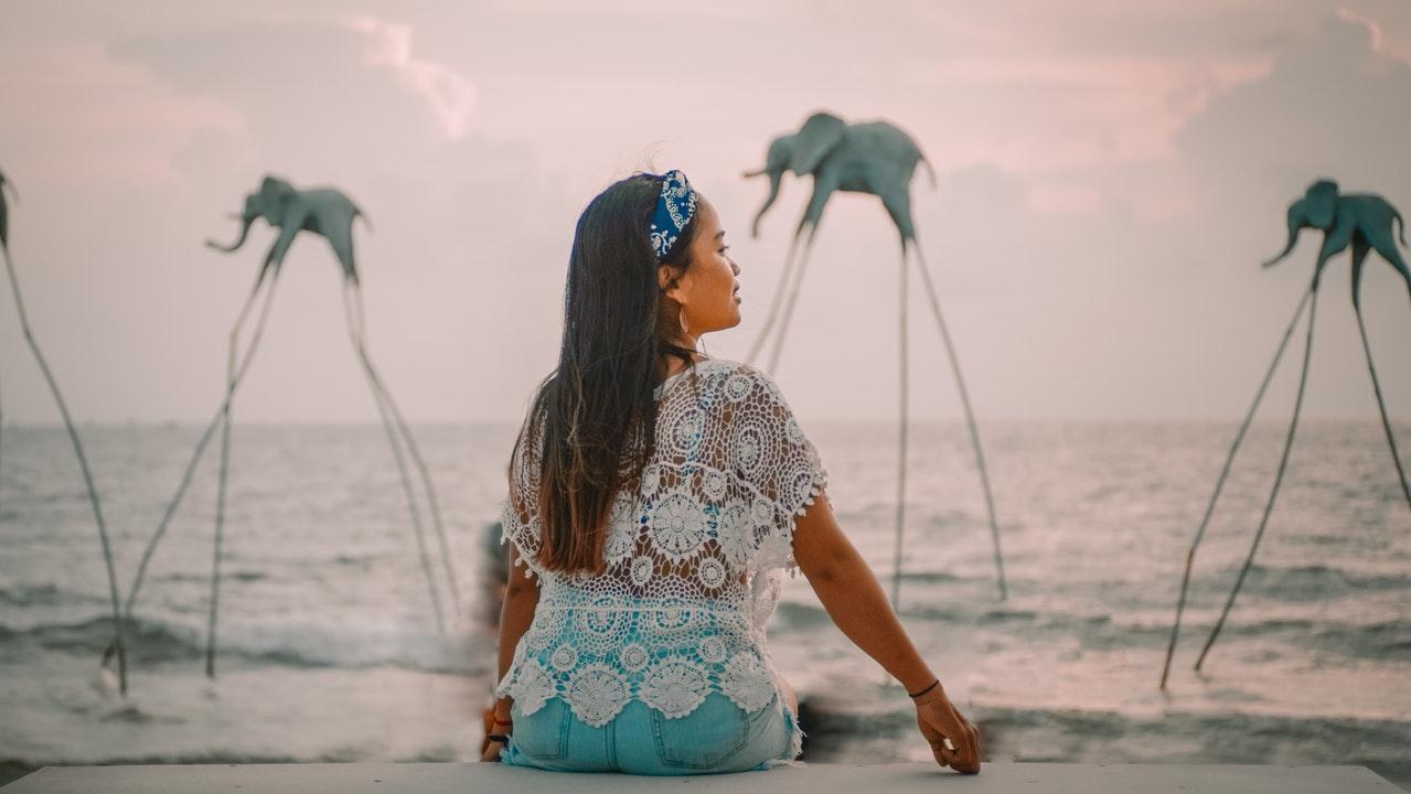 Woman sitting at ocean