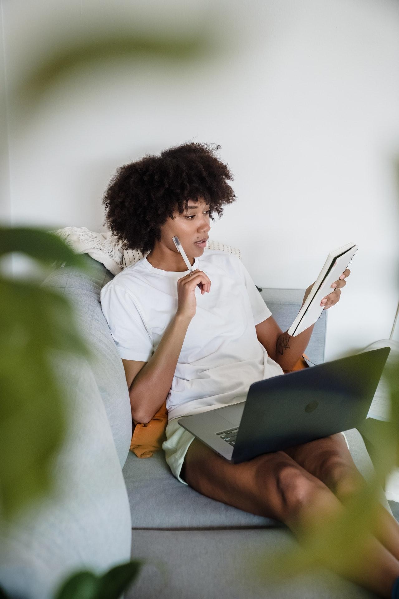 woman on couch with computer