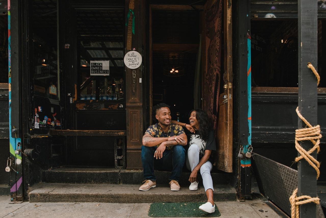 Couple sitting at a storefront