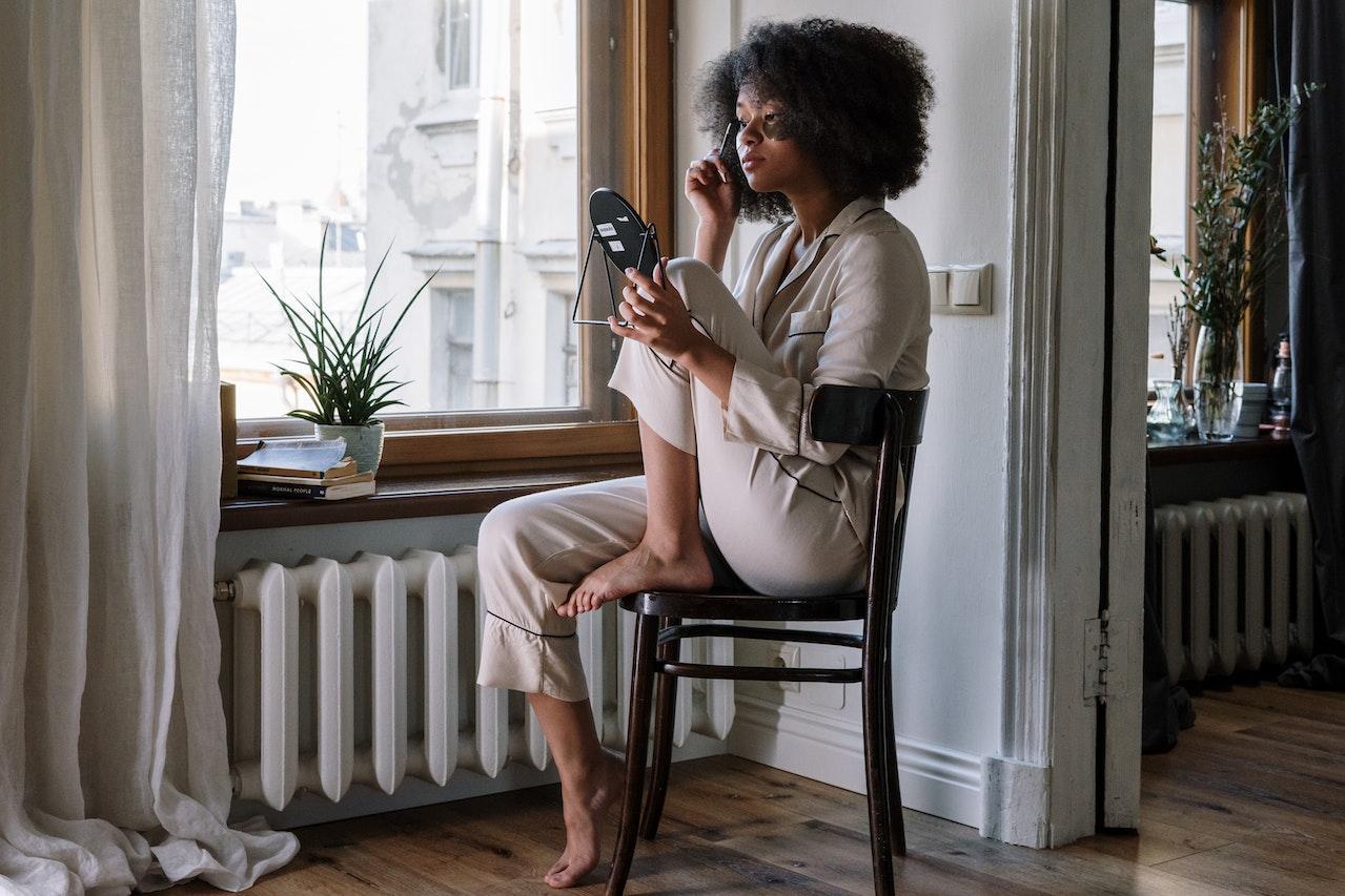 black woman using cosmetics