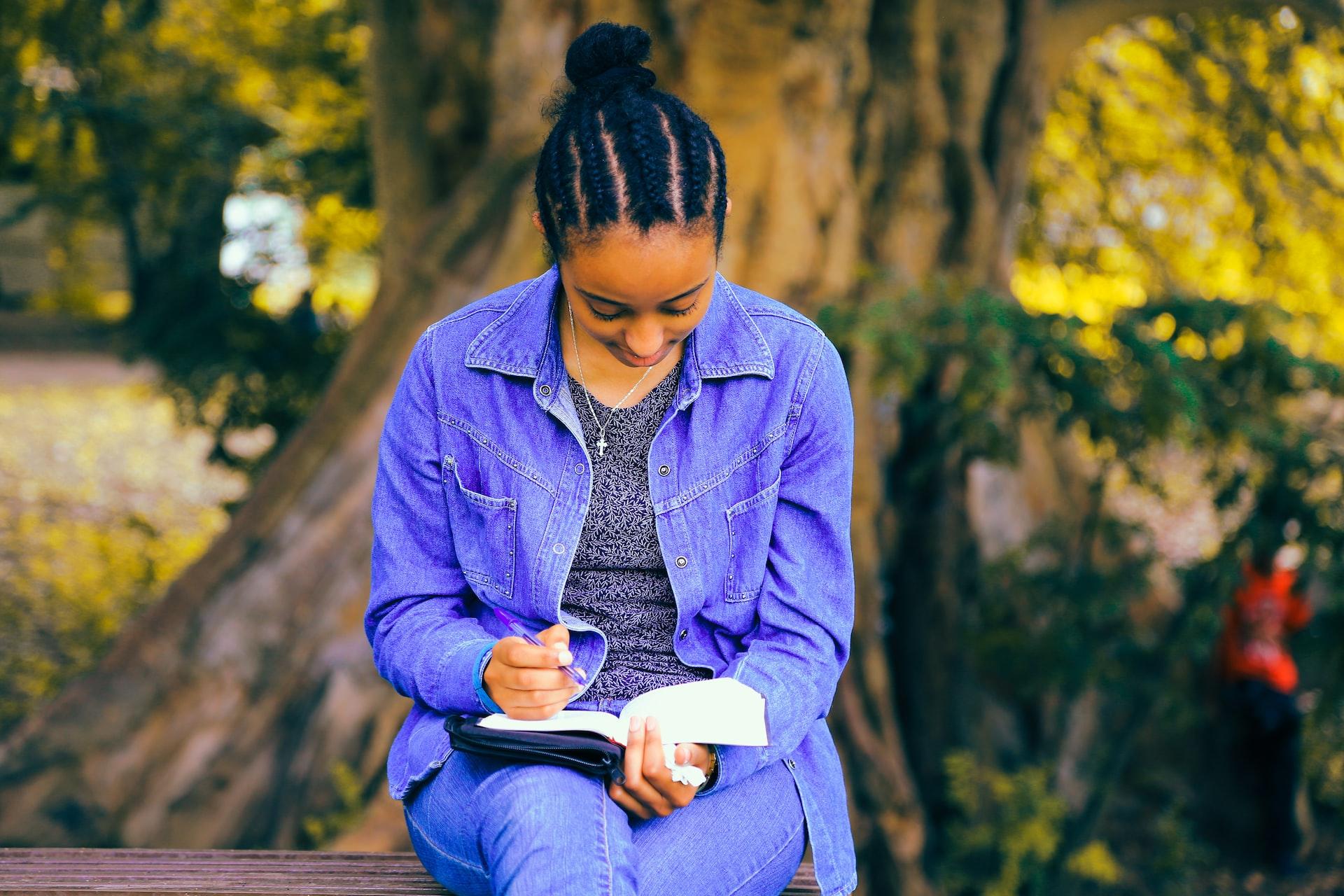 woman writing in a book