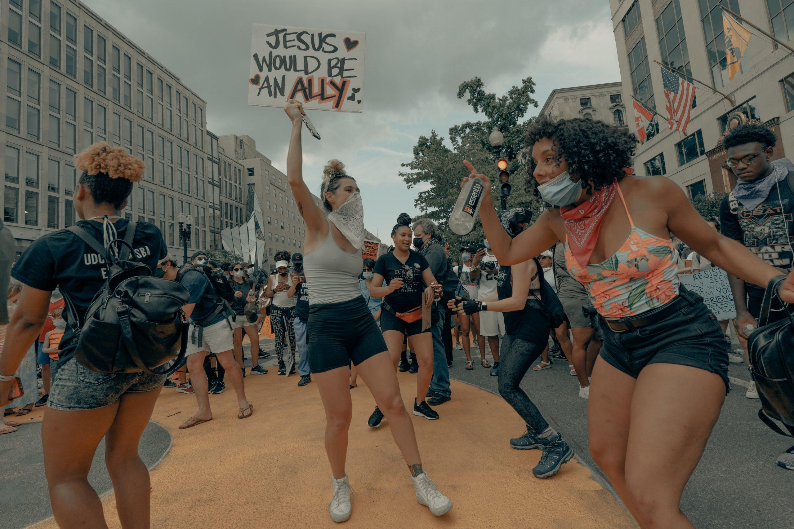 Women holding alliance sign