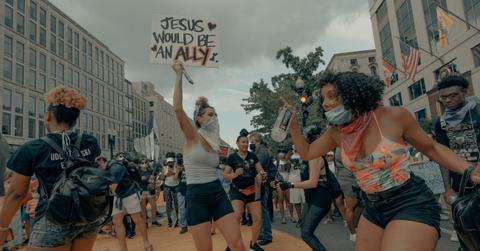 Women holding alliance sign