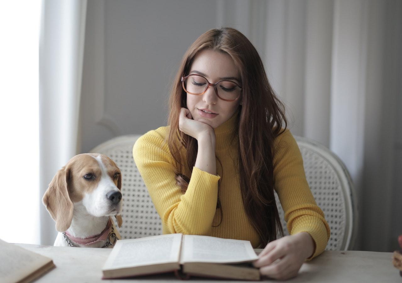 woman reading with dog