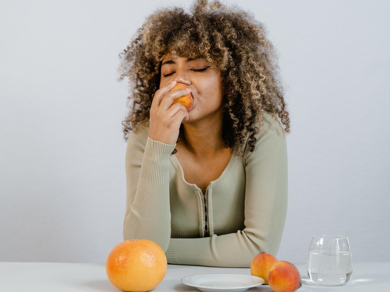 Woman eating fruit