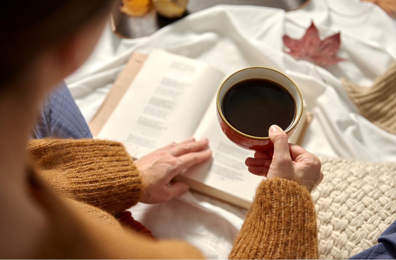 woman with book and coffee