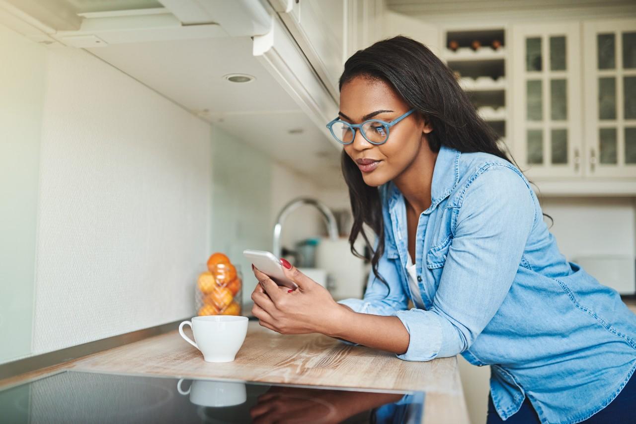 woman reading book on phone