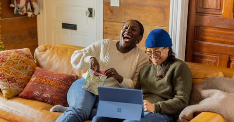 Two people happy on computer