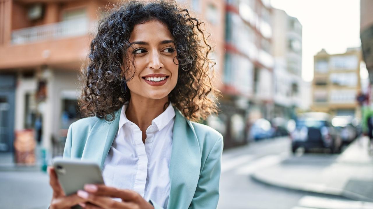 woman with phone in city