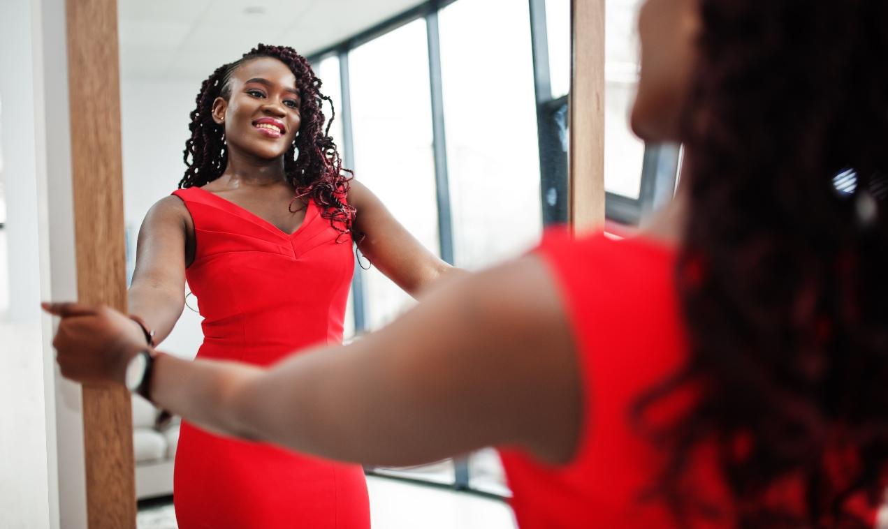 Black woman looking in mirror