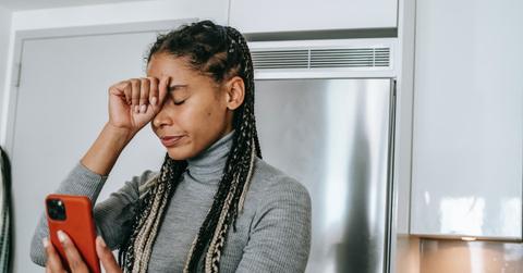 sad woman looking at news