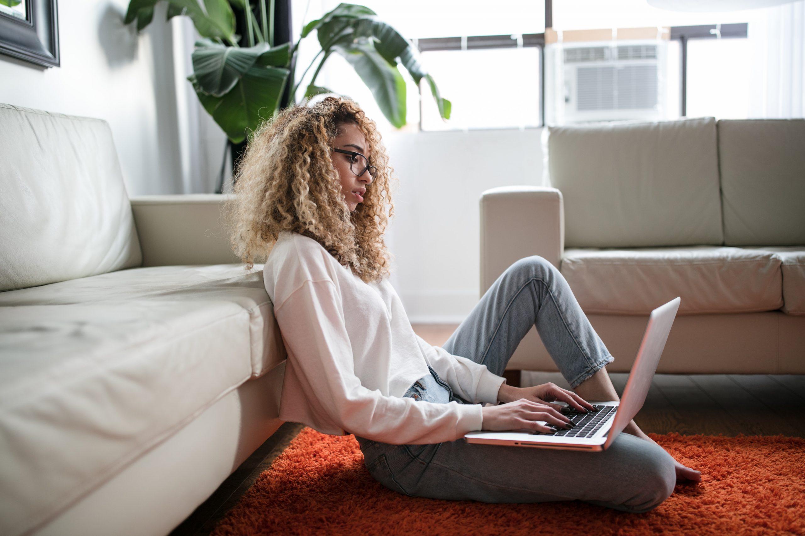 Women sitting on the floor working on laptop