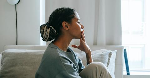 woman sitting by bed crying