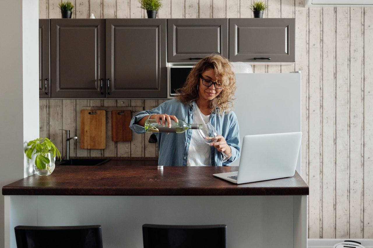 woman working from home drinking wine