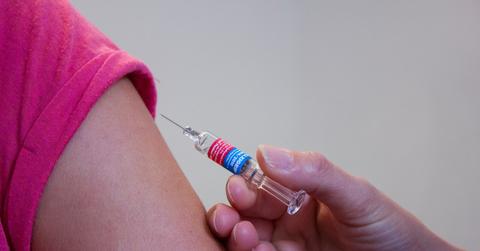 women getting vaccination shot in arm