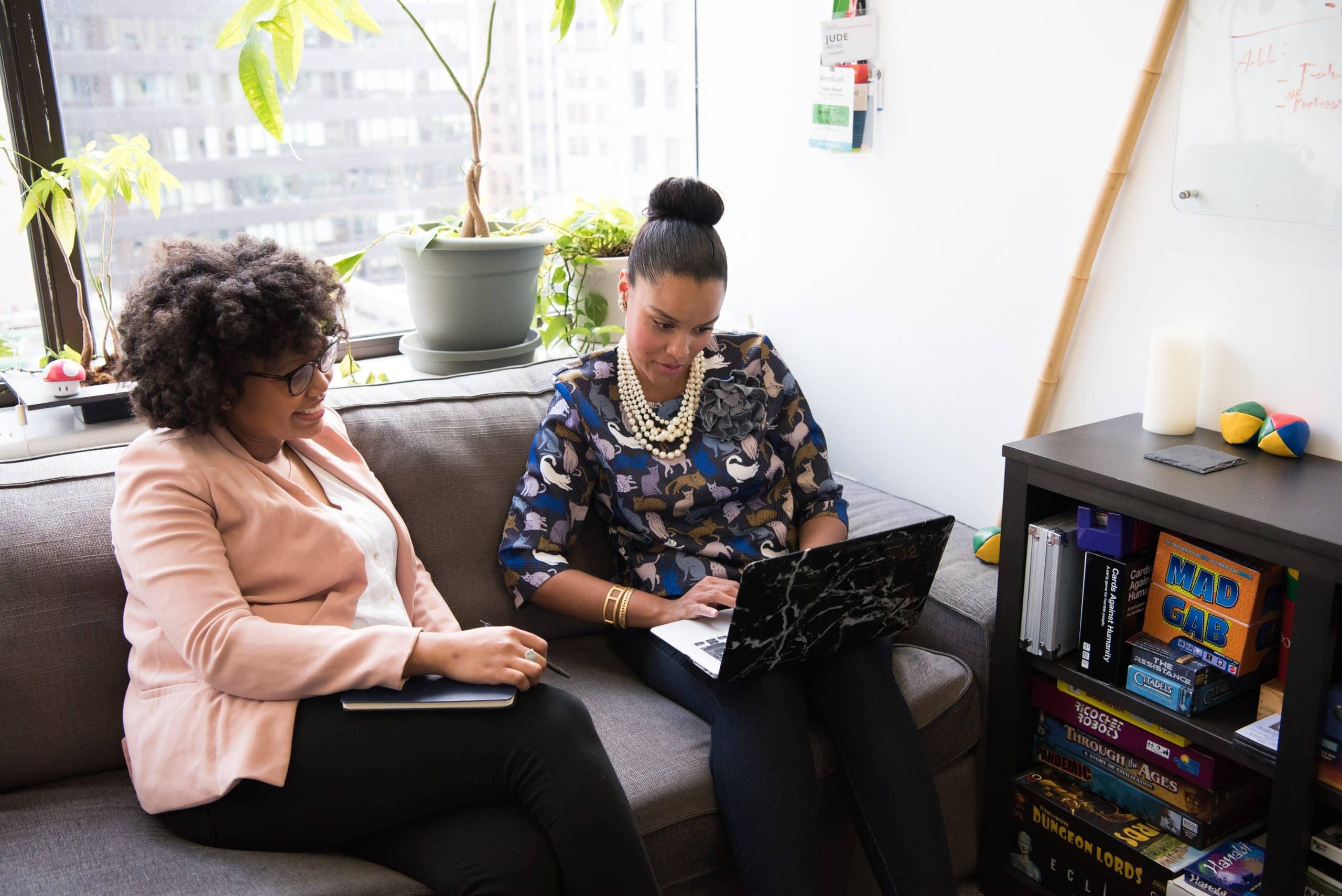 Two women using a laptop