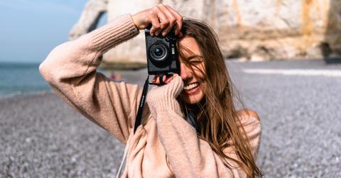 woman with camera at beach