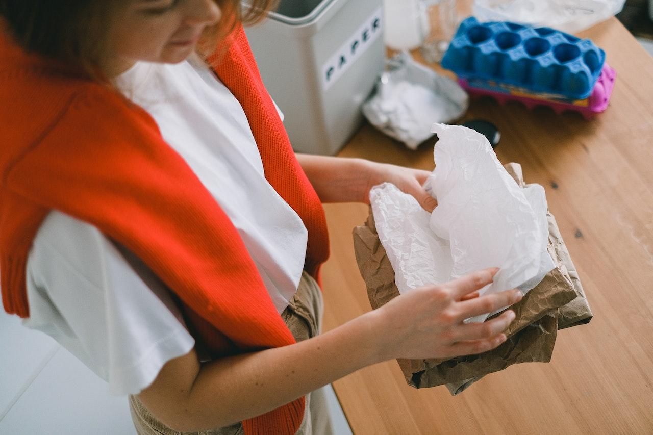 Woman sorting through recycling. 