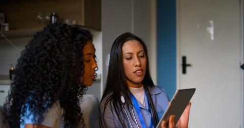 Female doctor talking to a woman