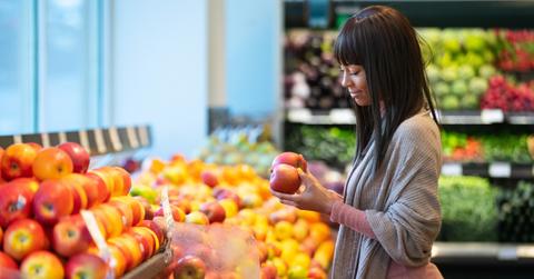 African American woman shopping for produce in grocery store