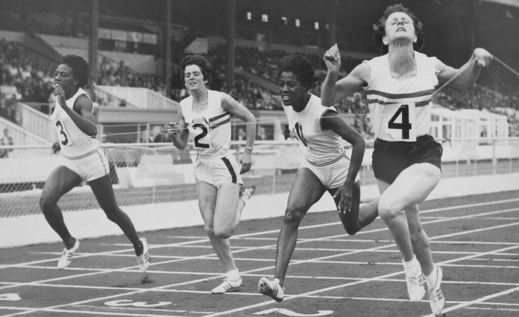 Two Strong Athletic Women Sprinter, Running on Black Background