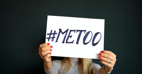 woman holding #metoo sign in front of face
