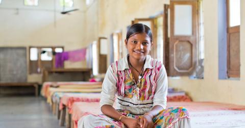 Laxmi Pal, 12 years old, sits on her bed in the Udaan Girls School in Hardoi, India. She was a featured girl in CARE’s “International Day of the Girl” art exhibition in Atlanta, GA. The Udaan Girls School provides girls with a core curriculum in language, math, and environmental science subjects. Udaan teachers also interweave activities such as morning assembly, sports (volleyball, soccer), bicycle riding and computer usage. Photo by Josh Estey.