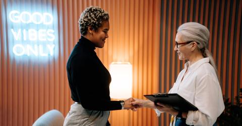 Two executives shaking hands in an office