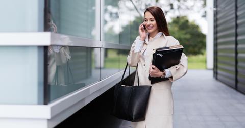 Portrait of young successful beautiful businesswoman going to office