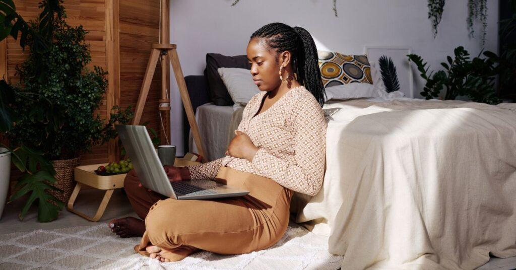 woman using laptop while sitting at home