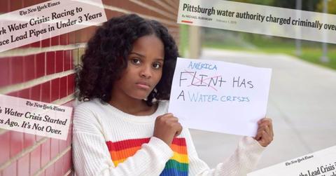young Black teen holding sign saying “America Has a Water Problem”