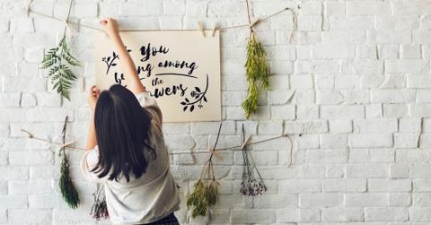 Young girl decorating a brick wall free image