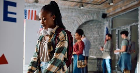Young black woman at voting booth during United States of America elections.