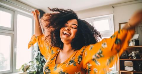 Positive plus size black woman dancing at home. Happiness and positivity. Generative AI