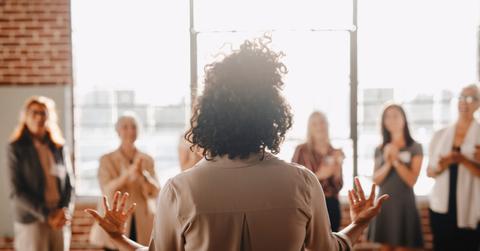 African american female empowering other colleagues in workplace