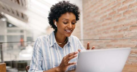 Ethnic small business owner having a video call in a warehouse
