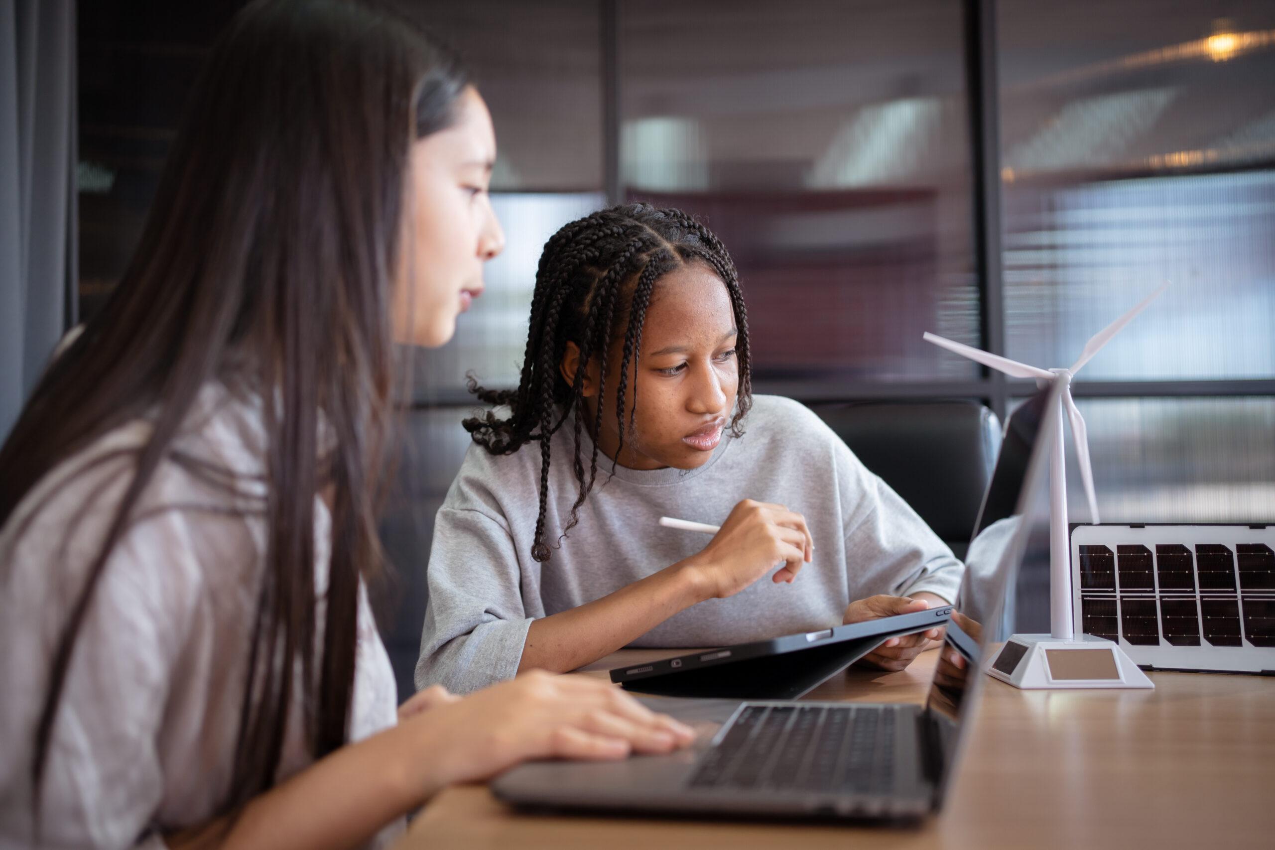 Group of international or multi ethnicity student having a discussion together about science project in class room.