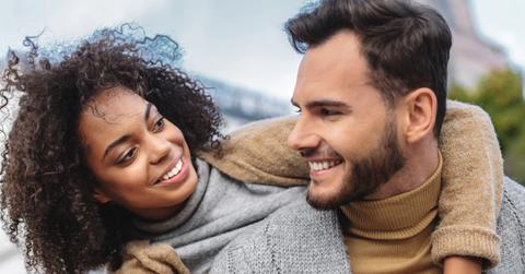 woman standing behind the back of a man